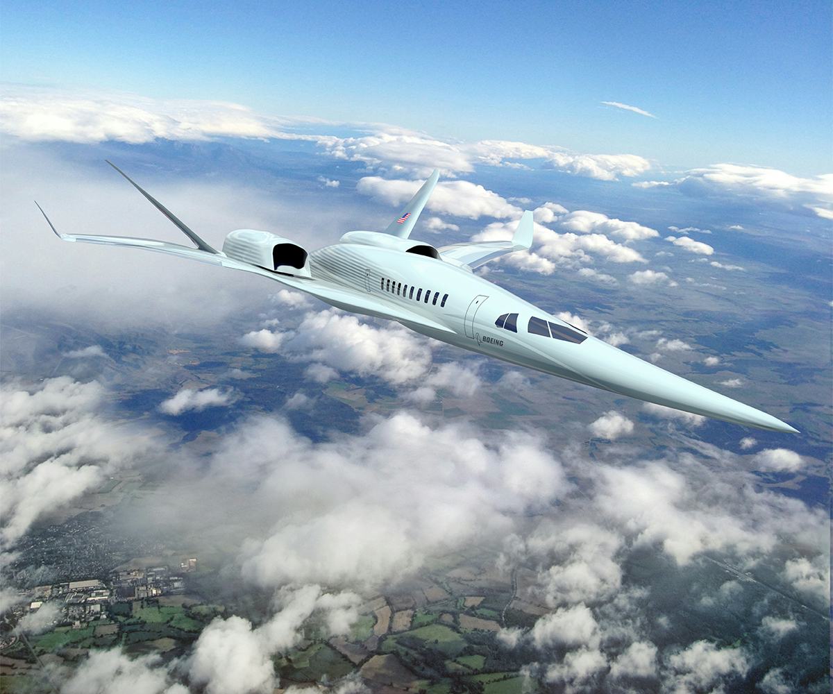 An overhead shot of the Boeing Phantom Works N+2 Supersonic soaring above the clouds with the horizon in the background.