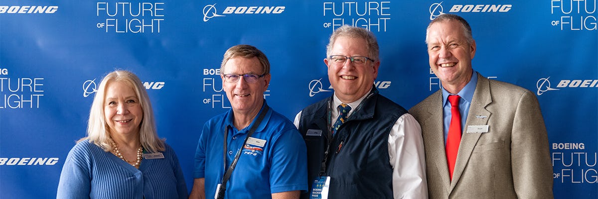 Group of people in front of a Boeing Future of Flight Banner