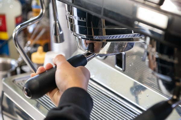 A barista making coffee with one of our Café's espresso machines.